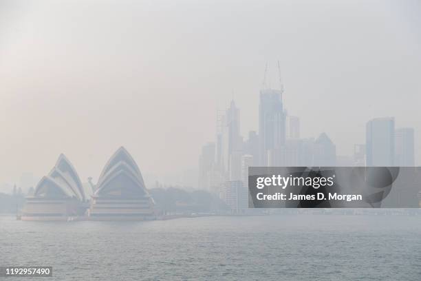 The Opera House is seen with smoke haze which enveloped Sydney Harbour on December 10, 2019 in Sydney, Australia. Smoke haze hangs over the city as...