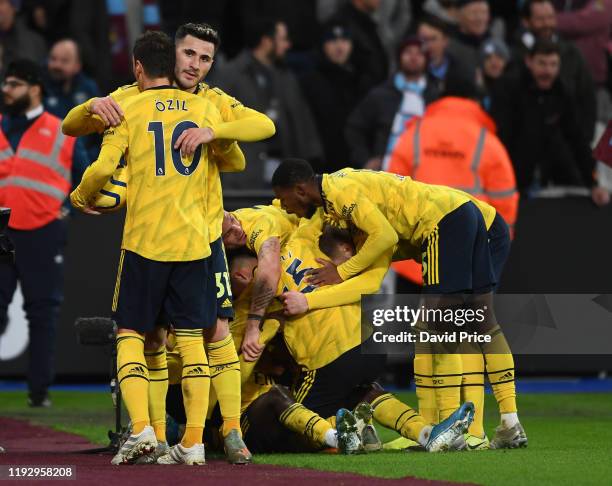 Mesut Ozil and Sead Kolasinac celebrate the 2nd Arsenal goal during the Premier League match between West Ham United and Arsenal FC at London Stadium...