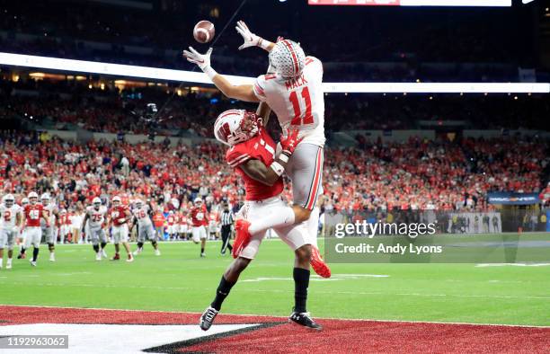 Austin Mack of the Ohio State Buckeyes reaches to catch a pass while defended by Faion Hicks of the Wisconsin badgers during the BIG Ten Football...