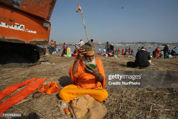 Sadhu puts a holy tilak on his forehead after taking a holy dip at Sangam, the confluence of the Ganges and Yamuna in Allahabad, India,January 10,...