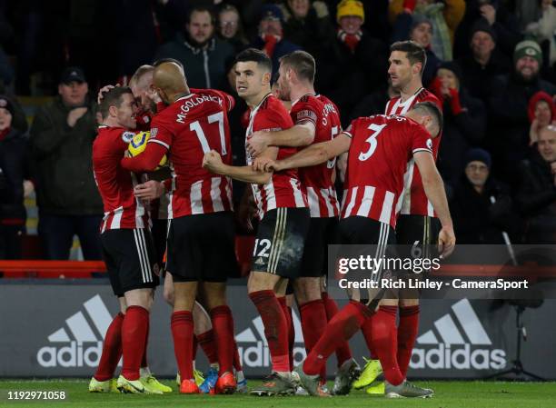 Sheffield United's Oliver McBurnie celebrates with teammates after scoring the opening goal during the Premier League match between Sheffield United...