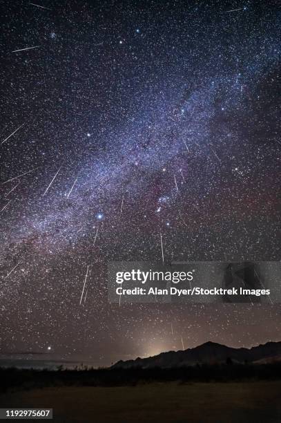 geminid meteor shower raining overhead above the chiricahua mountains. - geminid meteor shower 2017 stock pictures, royalty-free photos & images