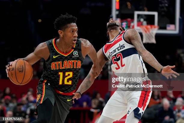 De'Andre Hunter of the Atlanta Hawks dribbles past Jordan McRae of the Washington Wizards in the first half at Capital One Arena on January 10, 2020...
