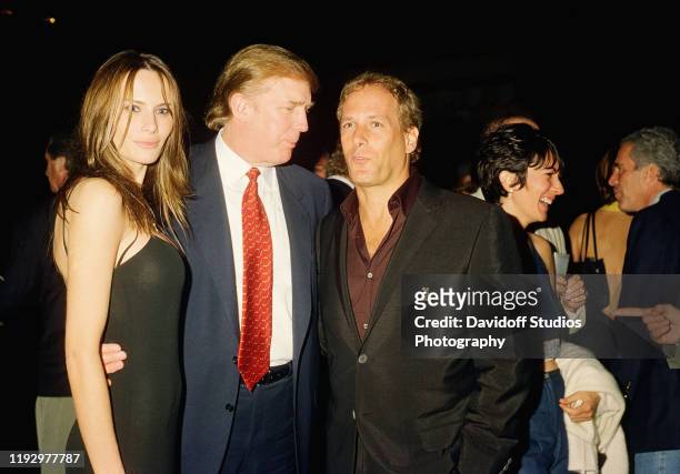 View of former model Melania Knauss and her boyfriend real estate developer Donald Trump as they pose with musician Michael Bolton at the Mar-a-Lago...