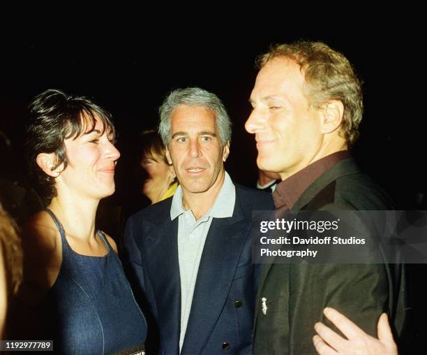 Ghislaine Maxwell, Jeffrey Epstein, and musician Michael Bolton pose for a portrait during a party at the Mar-a-Lago club, Palm Beach, Florida,...