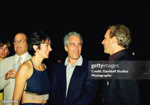 Ghislaine Maxwell, Jeffrey Epstein, and musician Michael Bolton pose for a portrait during a party at the Mar-a-Lago club, Palm Beach, Florida,...