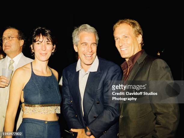 Ghislaine Maxwell, Jeffrey Epstein, and musician Michael Bolton pose for a portrait during a party at the Mar-a-Lago club, Palm Beach, Florida,...