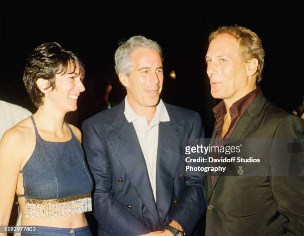 Ghislaine Maxwell, Jeffrey Epstein, and musician Michael Bolton pose for a portrait during a party at the Mar-a-Lago club, Palm Beach, Florida,...