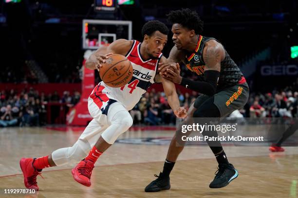 Ish Smith of the Washington Wizards dribbles past Brandon Goodwin of the Atlanta Hawks in the second half at Capital One Arena on January 10, 2020 in...