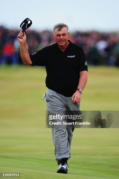 Darren Clarke of Northern Ireland acknowledges the crowd on the 18th green on his way to victory during the final round of The 140th Open...