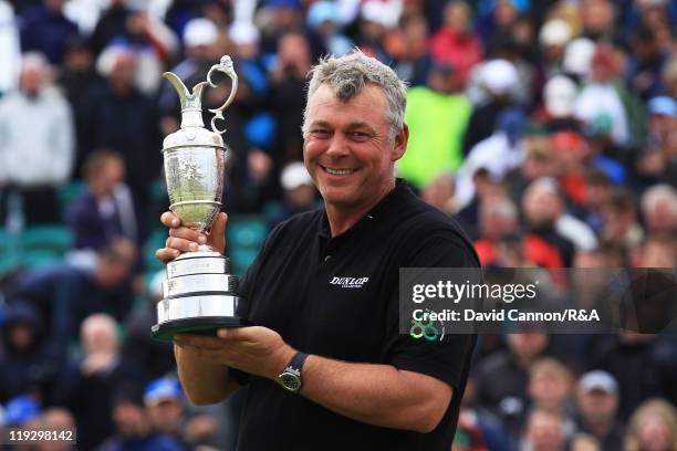 New Open Champion Darren Clarke of Northern Ireland poses with the Claret Jug following his victory during the final round of The 140th Open...