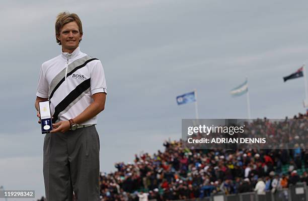 English golfer Tom Lewis poses with the Silver Medal after finishing highest ranking amateur 9 over par, on the final day of the 140th British Open...