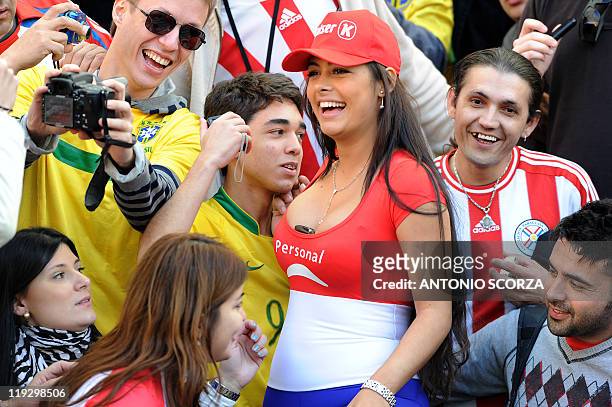 Paraguayan supporter Larissa Riquelme poses with Brazilian supporters before a 2011 Copa America quarter-final football match held at the Ciudad de...