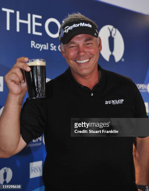 Darren Clarke of Northern Ireland toasts his victory with a pint of Guinness at the end of the final round of The 140th Open Championship at Royal St...