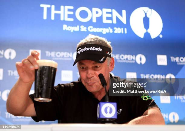 Darren Clarke of Northern Ireland toasts his victory with a pint of Guinness following the final round of The 140th Open Championship at Royal St...