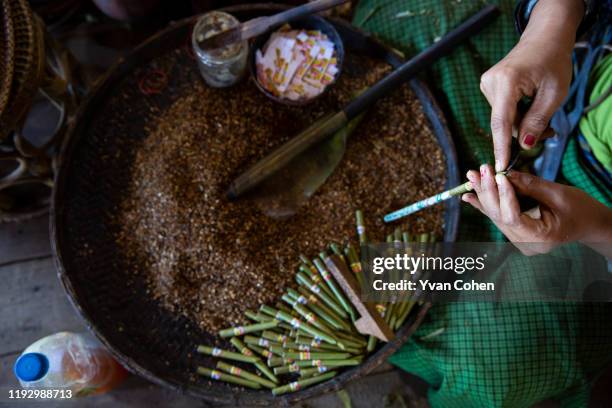Overview of a woman making traditional, cheroot cigars at a local production facility in the Inle lake area.