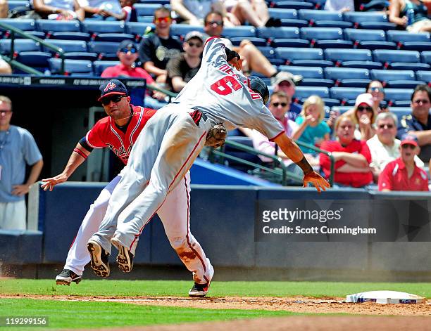 Ian Desmond of the Washington Nationals is tagged out at third base by Martin Prado of the Atlanta Braves at Turner Field on July 17, 2011 in...