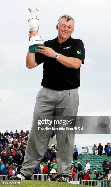 Darren Clarke of Northern Ireland poses with the Claret Jug following his victory at the end of the final round of The 140th Open Championship at...