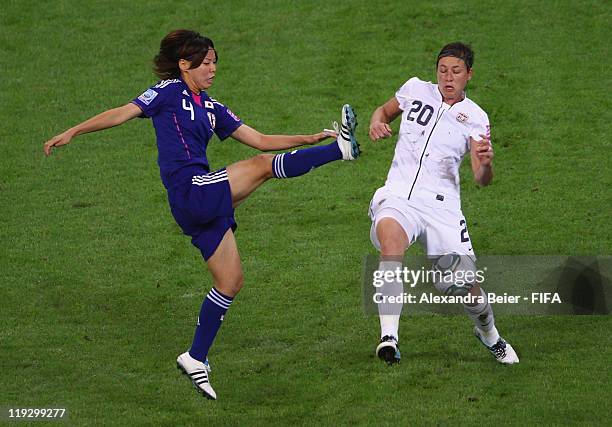 Saki Kumagai of Japan fights for the ball with Abby Wambach of USA during the FIFA Women's World Cup Final match between Japan and USA at the FIFA...