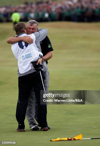 Darren Clarke of Northern Ireland embraces his caddy John Mulrooney on the 18th green following his victory during the final round of The 140th Open...