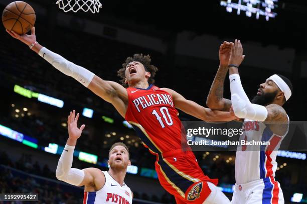 Jaxson Hayes of the New Orleans Pelicans grabs a rebound against Markieff Morris and Blake Griffin of the Detroit Pistons during the first half at...