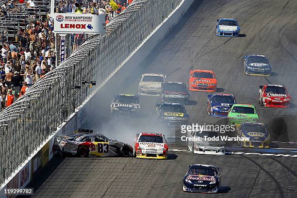 Brian Vickers, driver of the Red Bull Toyota, spins on the front stretch during the NASCAR Sprint Cup Series LENOX Industrial Tools 301 at New...