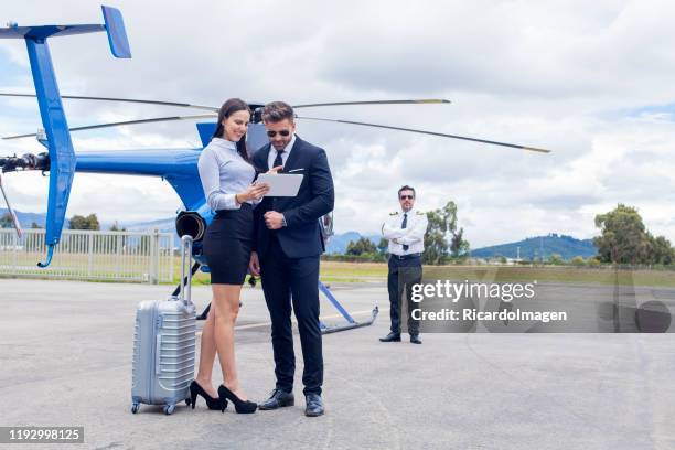 businessmen getting off a helicopter - helicopter money stock pictures, royalty-free photos & images