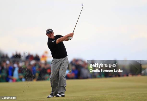 Darren Clarke of Northern Ireland hits his approach shot on the 18th hole during the final round of The 140th Open Championship at Royal St George's...