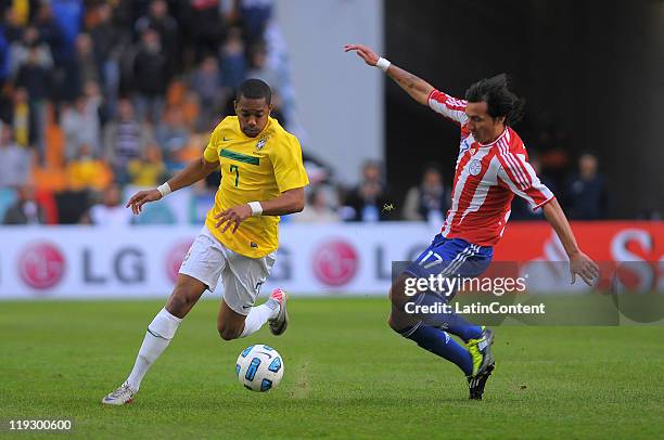 Robinho of Brazil struggles for the ball with Aureliano Torres of Paraguay during a match as part of Finals Quarters of 2011 Copa America at Ciudad...