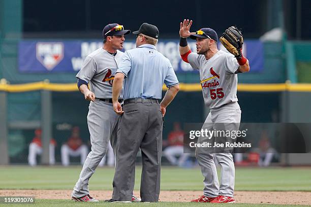 Ryan Theriot and Skip Schumaker of the St. Louis Cardinals argue a call with second base umpire Mike Muchlinski during the game against the...