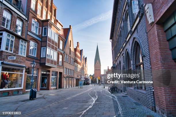 shopping street in the old town of lüneburg, germany - brick pathway stock pictures, royalty-free photos & images