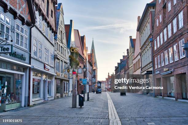 shopping street in the old town of lüneburg, germany - lüneburg stock pictures, royalty-free photos & images