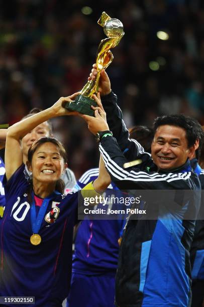 Head coach Norio Sasaki and Homare Sawa celebrates with the cup after winning the FIFA Women's World Cup Final match between Japan and USA at the...