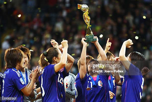 The team of Japan celebrates with the cup after winning the FIFA Women's World Cup Final match between Japan and USA at the FIFA World Cup stadium...