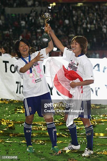 Yuki Nagasato of Japan and Kozue Ando of Japan celebrate with the winning trophy after winning 5-3 after penalty shoot-out the FIFA Women's World Cup...