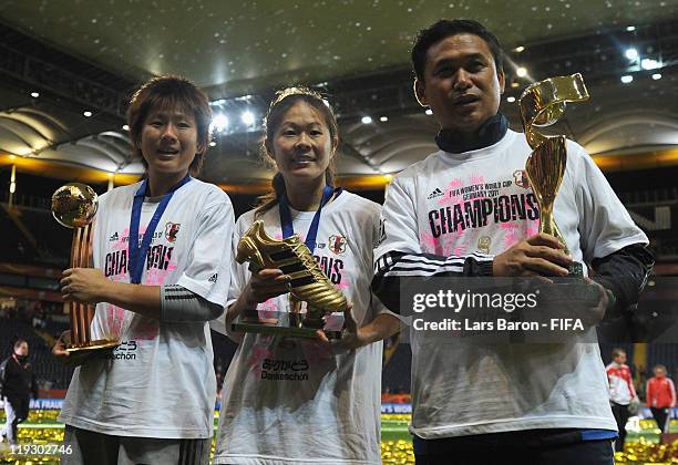 Head coach Norio Sasaki of Japan holds the trophy next to goalkeeper Ayumi Kaihori and Homare Sawa after winning the FIFA Women's World Cup Final...