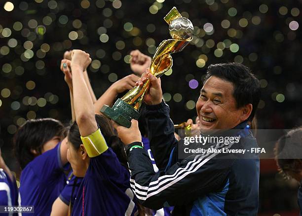 Norio Sasaki the coach of Japan lifts the Women's World Cup after victory over USA in the FIFA Women's World Cup Final match between Japan and USA at...