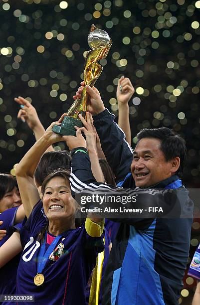 Homare Sawa the captain of Japan and Norio Sasaki the coach of Japan lift the Women's World Cup after victory over USA in the FIFA Women's World Cup...
