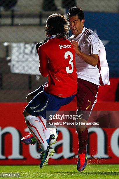Arturo Vidal, from Chile, fights for the ball with Tomas Rincon, from Venezuela, during a quarter final match at Bicentenarium Stadium on July 17,...