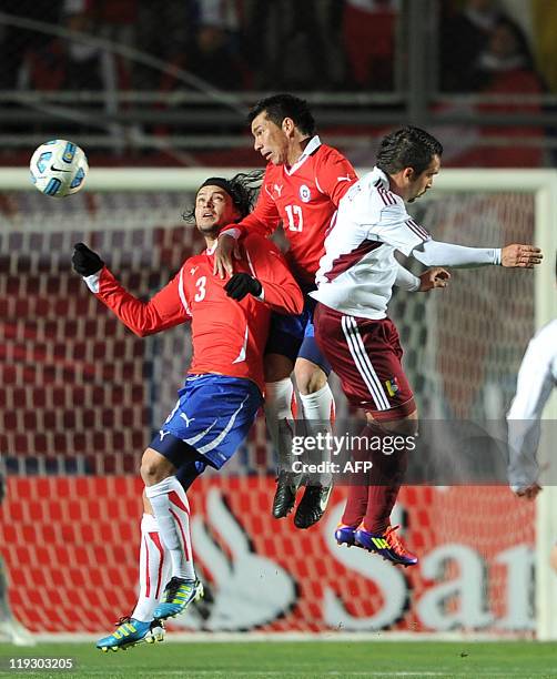 Venezuelan forward Giancarlo Maldonado vies for the ball with Chilean defender Waldo Ponce and midfielder Gary Medel during their 2011 Copa America...