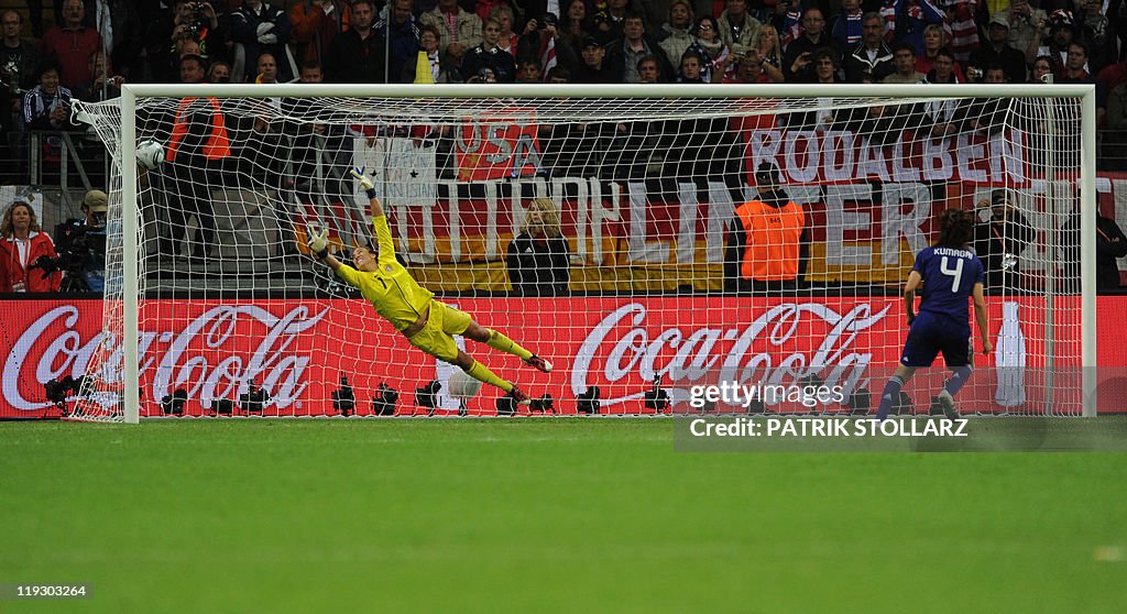 Japan's defender Saki Kumagai (R) scores