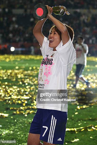 Kozue Ando of Japan lifst the trophy after winning 5-3 after penalty shoot-out the FIFA Women's World Cup Final match between Japan and USA at the...