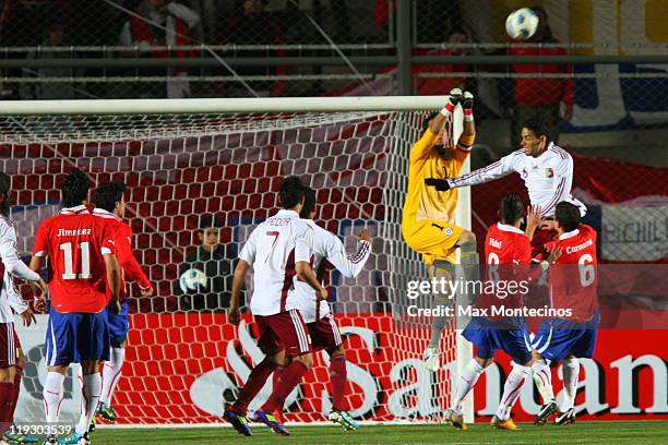 Claudio Bravo from Chile fights for the ball against Gabriel Cichero from Venezuela during a quarter final match between Chile and Venezuela at...