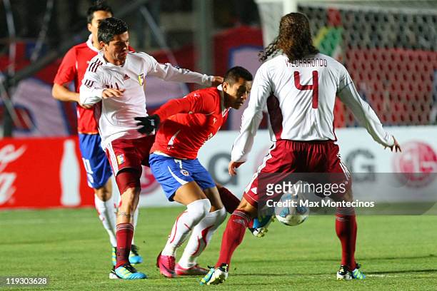 Alexis Sánchez from Chile fights for the ball against Oswaldo Vizcarrondo from Venezuela during a quarter final match between Chile and Venezuela at...
