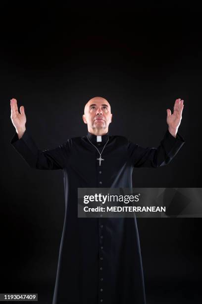 priest blessing praying god open hands with cassock - cassock stock pictures, royalty-free photos & images