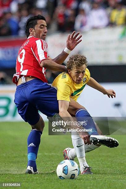 Lucas of Brazil struggles for the ball with Lucas Bairros of Paraguay during a quarter final match between Brazil and Paraguay as part of the Copa...