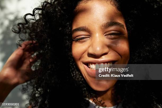 portrait of smiling female against white wall - close up portraits foto e immagini stock