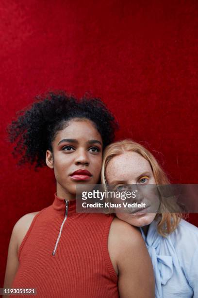 close-up of female friends standing outdoors - serious couple stock pictures, royalty-free photos & images