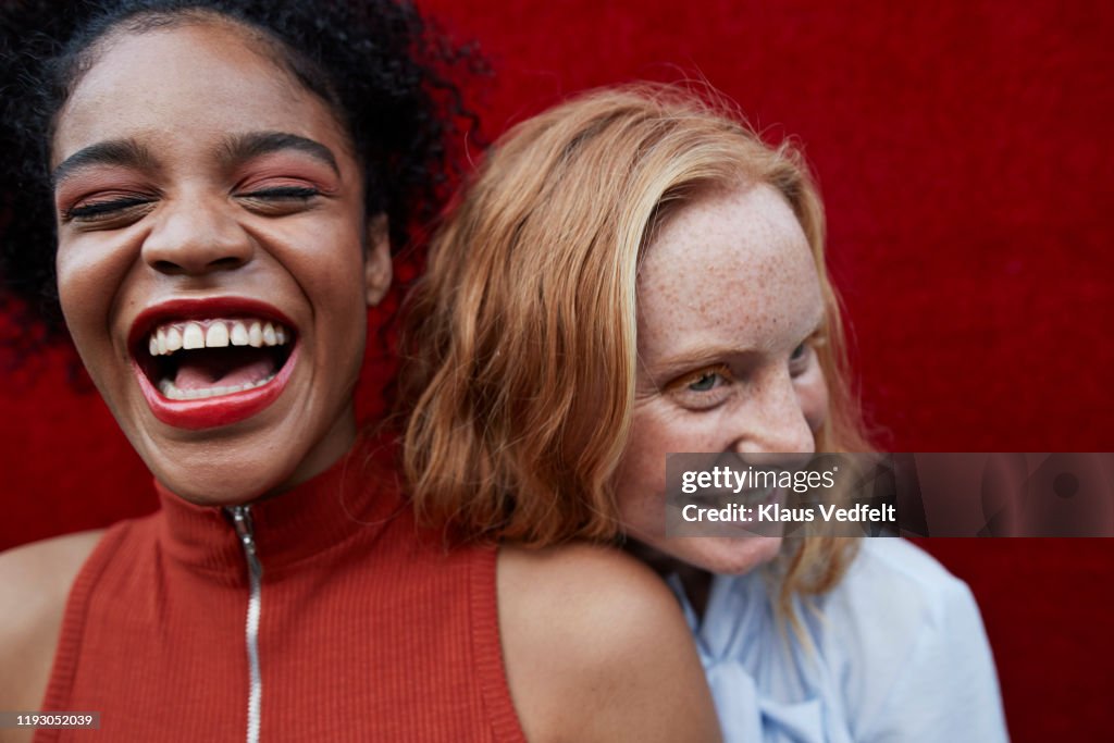 Close-up of happy young females standing outdoors