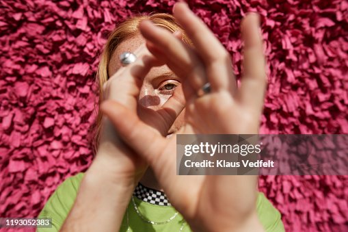 Beautiful woman gesturing against textured wall Beautiful woman gesturing against textured wall